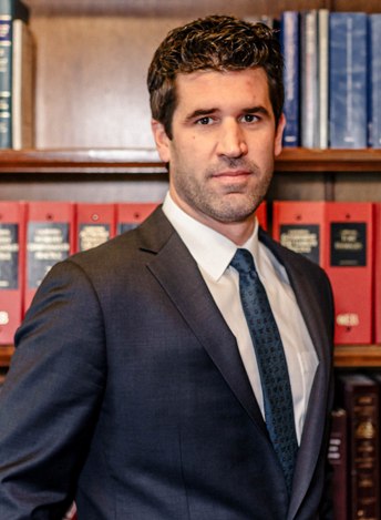 Attorney Taylor Ernst standing in a library